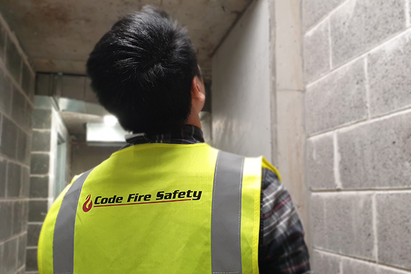 code fire safety engineer inspecting building